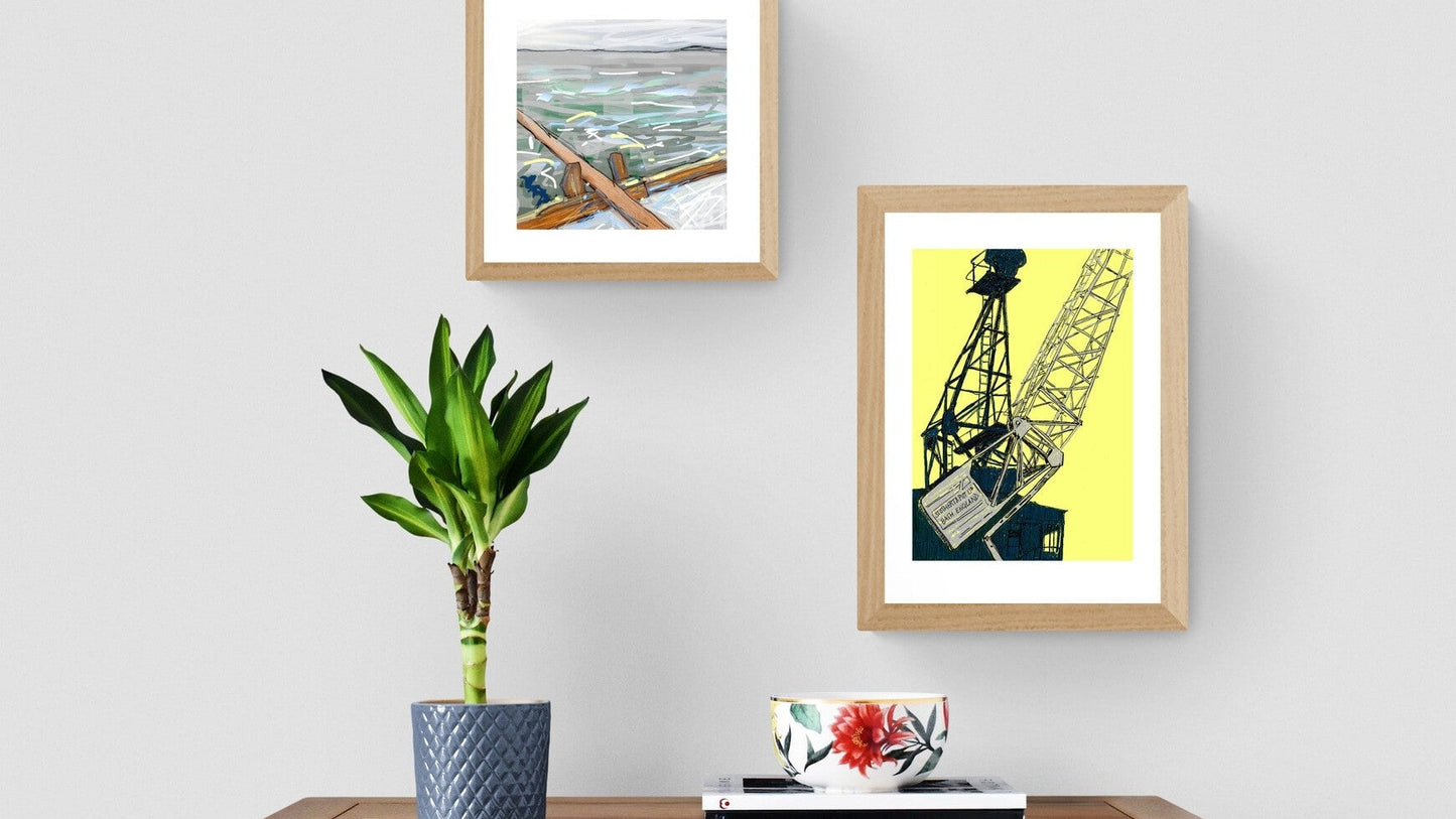 rowing boat and crane prints on grey wall with plant and chest of drawers
