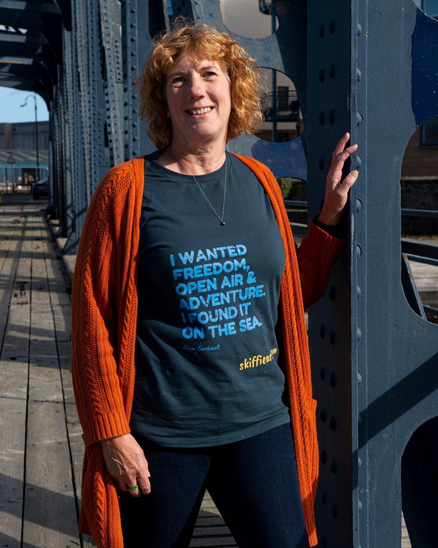 artist red hair on swing bridge in sunshine