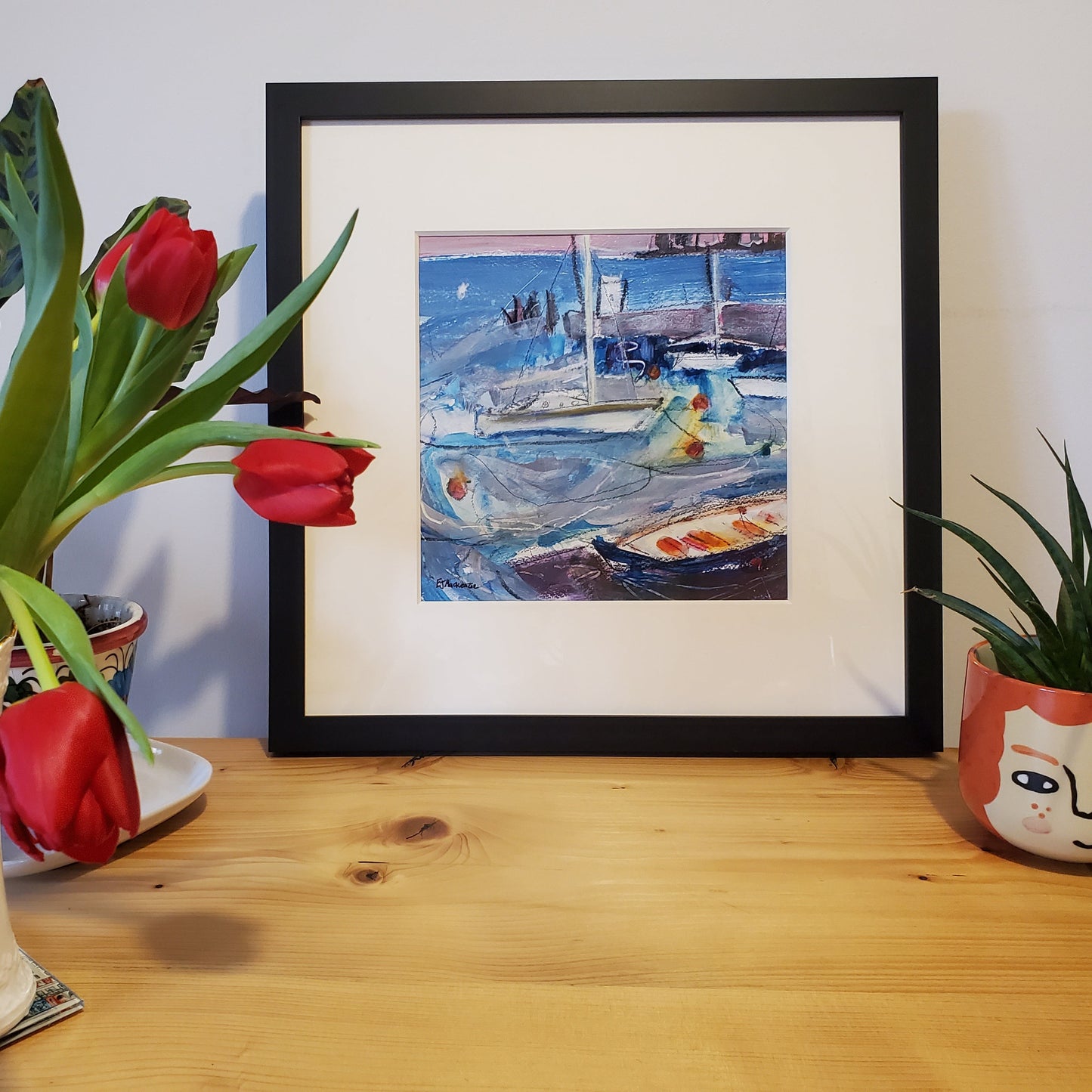 Fraed harbour painting on shef with tulips and plant